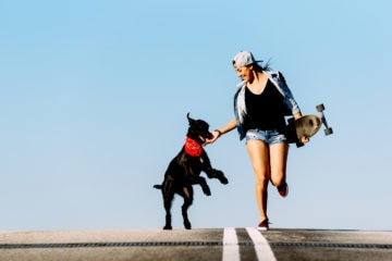 Skatergirl playing with her dog