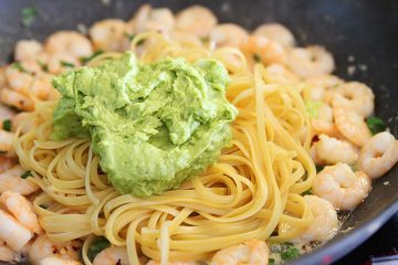 shrimp and avocado pasta in a pan