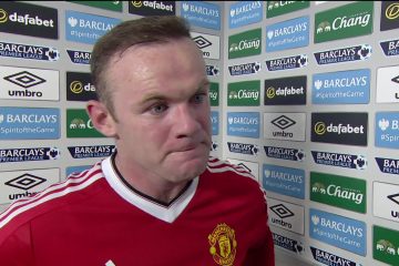 Wayne Rooney looking upset in an interview