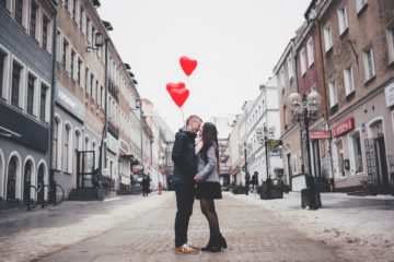 couple on the street with heart balloons